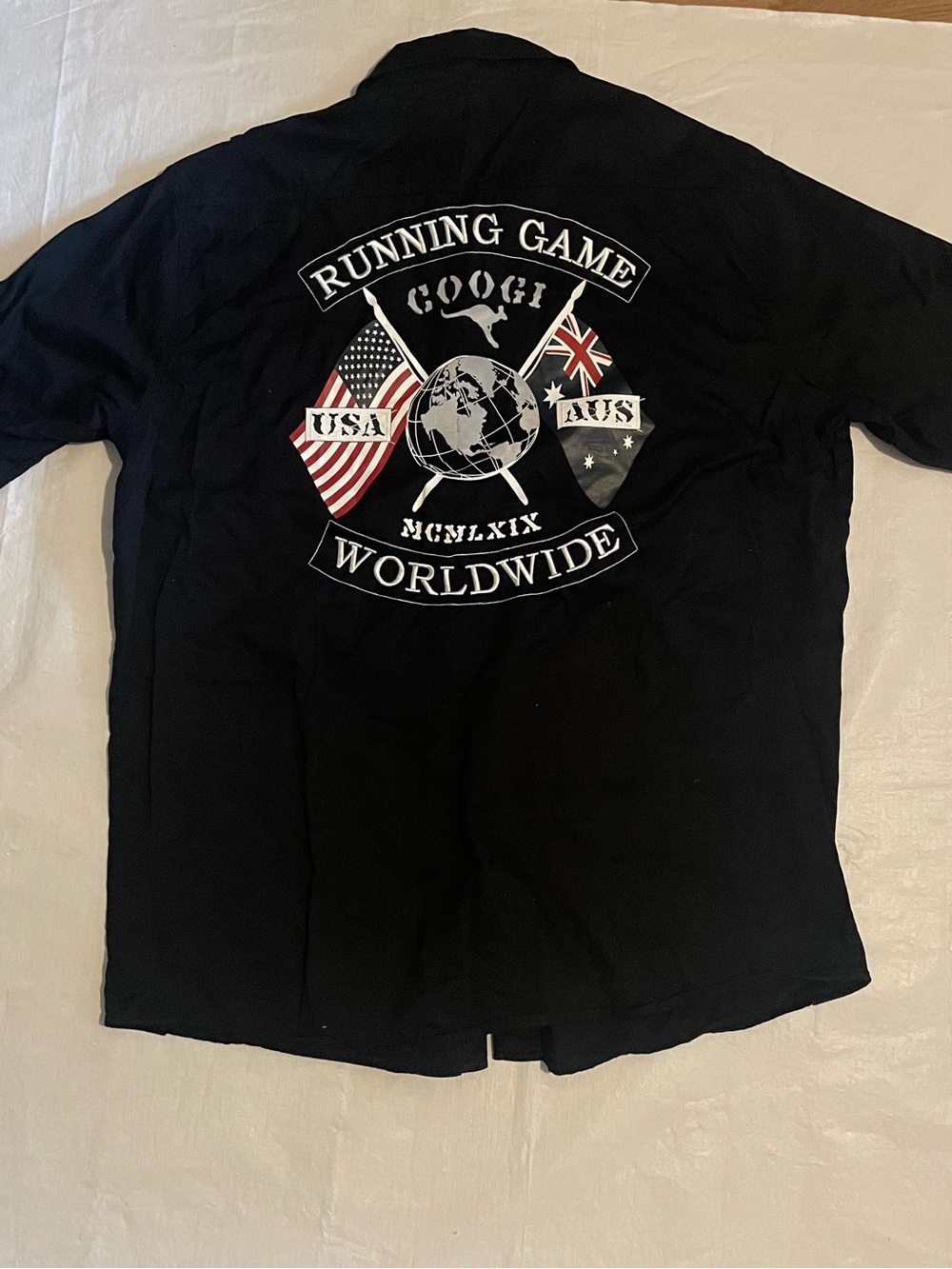 COOGI Black Polo with 'Running Game Worldwide' Back Graphic
